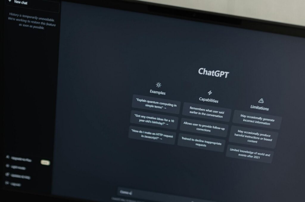 Hands typing on a laptop displaying the ChatGPT interface, showcasing AI technology.
